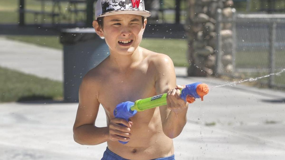 Dennis Babcock, 10, squirts water at his friends during a hot day at Columbia Park in Kennewick. Monday’s high at the Pasco Airport was 98. The Tri-Cities can expect triple-digit temperatures all week, with a high of up to 107 degrees Friday, said the National Weather Service. It issued a heat advisory from noon Wednesday through 8 p.m. Friday. Babcock was with his mother, Yoko Babcock of Kennewick.
