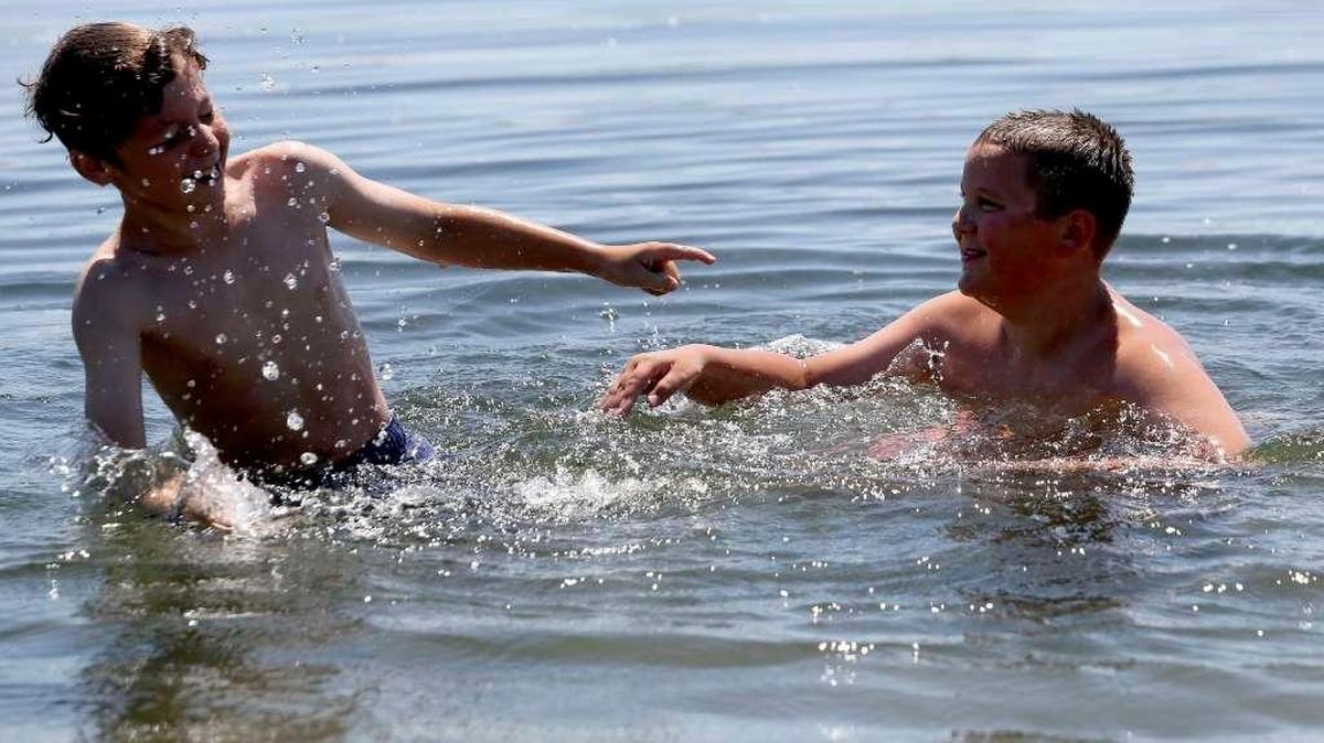 Damian Lewis, right, 11, of West Richland, splashes his friend Dennis Routh, 10, of West Richland, while playing in the Columbia River at Leslie Grove Park in Richland in July.