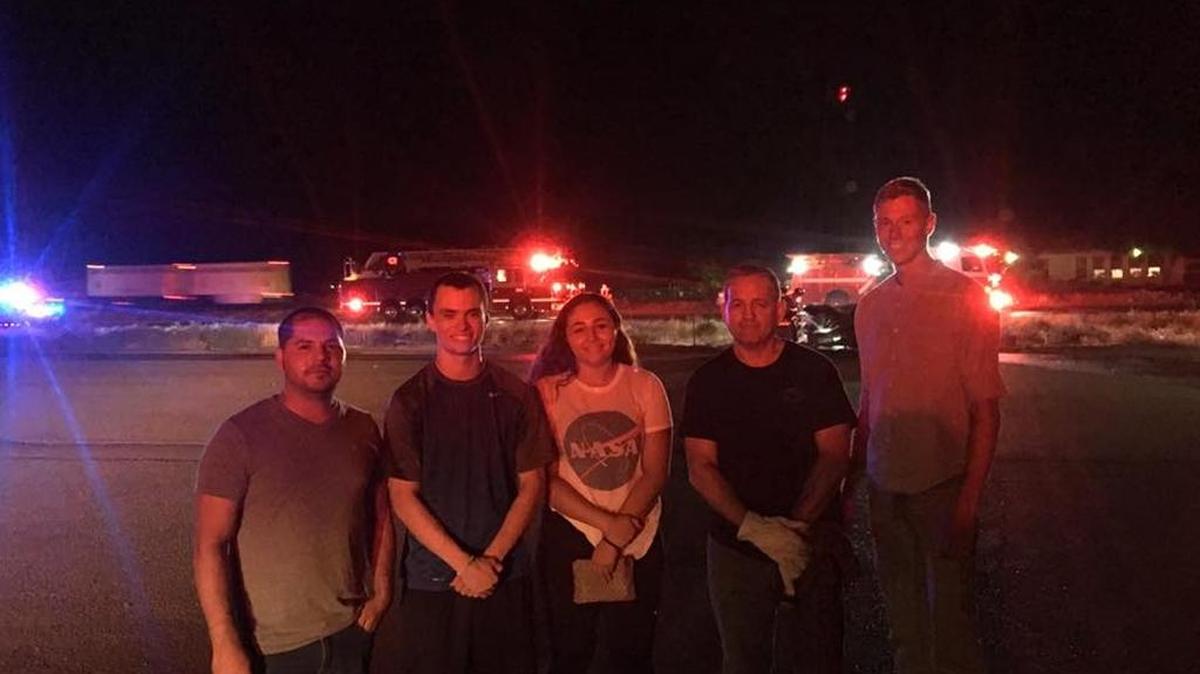 Masood Zarifi, left, stands with other passersby who helped an elderly Kennewick man out of a burning car Wednesday night in Pasco.