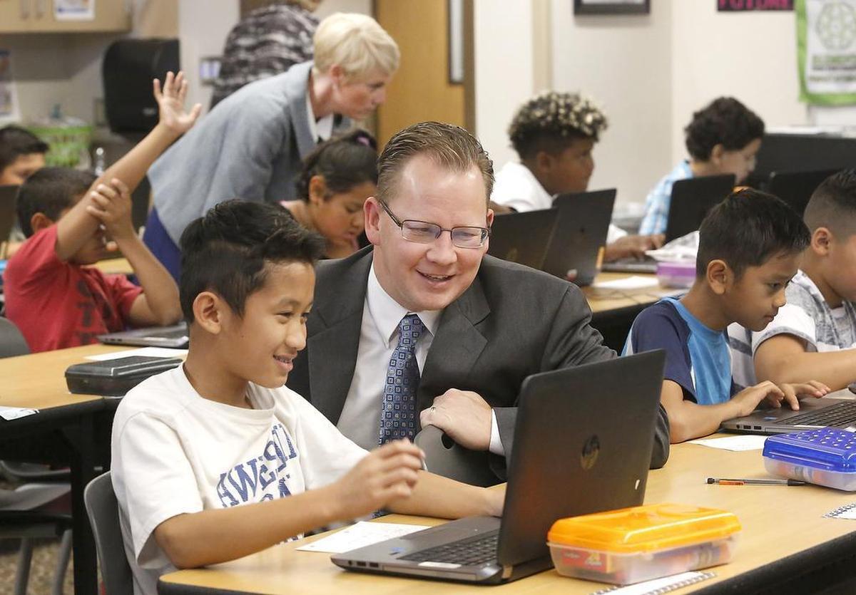 September 19, 2017 - State Superintendent of Public Instruction Chris Reykdal checks out a classroom computer assignment that fifth-grade student Tha Dar Ler works on at Marie Curie STEM Elementary School in Pasco. Reykdal visited classrooms at the Pasco school before a news conference to announce submitting an Every Student Succeeds Act plan to the federal government.