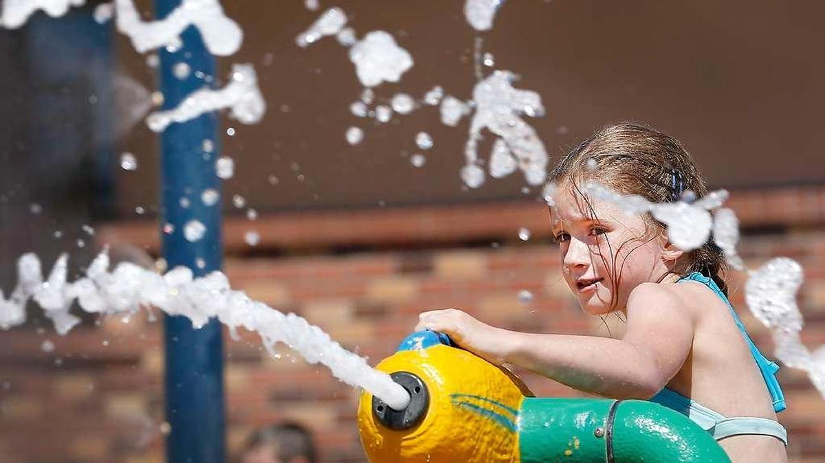 Keyala Krumland watches streams of water jet from the high-powered squirt guns in June in the water park at the Southridge Sports and Events Complex in Kennewick. The spray park was crowded with youngsters and their parents seeking relief from the rising temperatures.