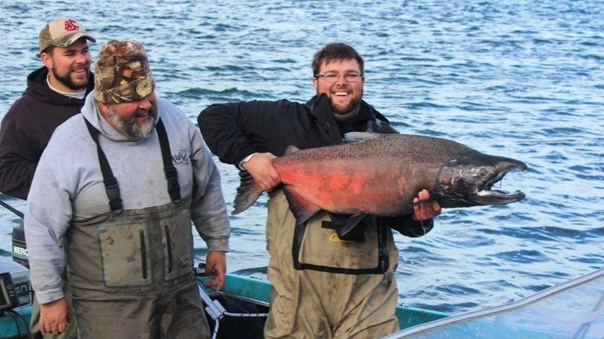 Jacob Ostrom hoists a fall chinook salmon he caught in the King of the Reach Live Capture Derby in 2014.