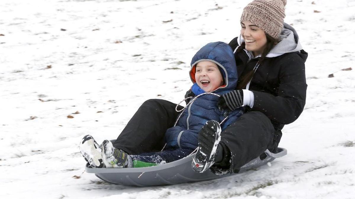 Rashel Allen of Richland and her son, Cash, 5, take time Friday morning to play in the snow at Carmichael Hill in Richland. Allen said she moved here from Olympia this past summer and had heard about the popular sledding hill for when the snow arrives in the winter. Watch a video of a ride at tricityherald.com/video