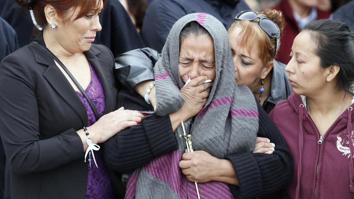 This photo taken in February 2015 was named the Washington Photo of the Year by The Associated Press. Agapita Montes-Rivera, 60, the mother of Antonio Zambrano-Montes, center, is comforted following the funeral Mass for her son in February 2015 at St. Patrick Catholic Church in Pasco.