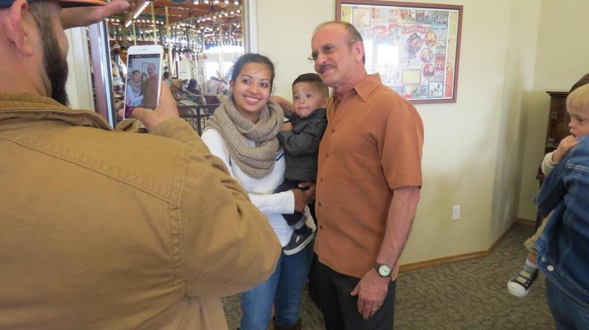 Former Kadlec Neonatal Intensive Care Unit director Dr. Anthony Hadeed poses with a NICU family — Marcos, Julie and Maximo Tapia — during a retirement celebration Sunday in Kennewick. Maximo, 19 months, was one of Hadeed’s patients.
