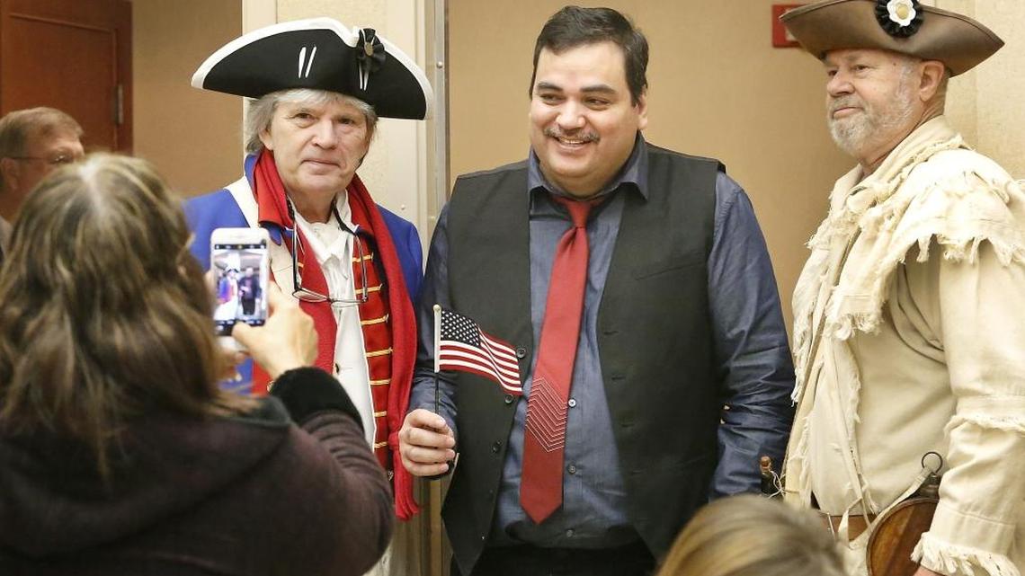 Raul Mendez Garcia celebrates his U.S. citizenship Monday by posing for photos with Barry Moravek, left, and Larry Flint, members of the Sons of the American Revolution, during a ceremony held at the U.S. District Court in Richland. Watch a video at: tricityherald.com/video