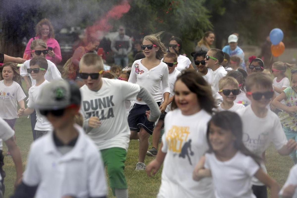 A crowd of kids run through the start of the kids color run. The free event, hosted by Central Christian Childcare, was organized to provide a fun activity to kick off summer.