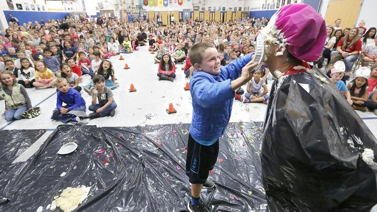 First-grader Cooper Cissne smears a cream pie on the face of his mother, Diana Cissne, the principal at Maya Angelou Elementary School in Pasco, during their end of year assembly Friday. Students there earn school currency, called “Maya Cares Bucks,” during the year for being good citizens. Cooper spent $1,000 of his school bankroll for the opportunity to wield the pie. Watch a video at tricityherald.com/video
