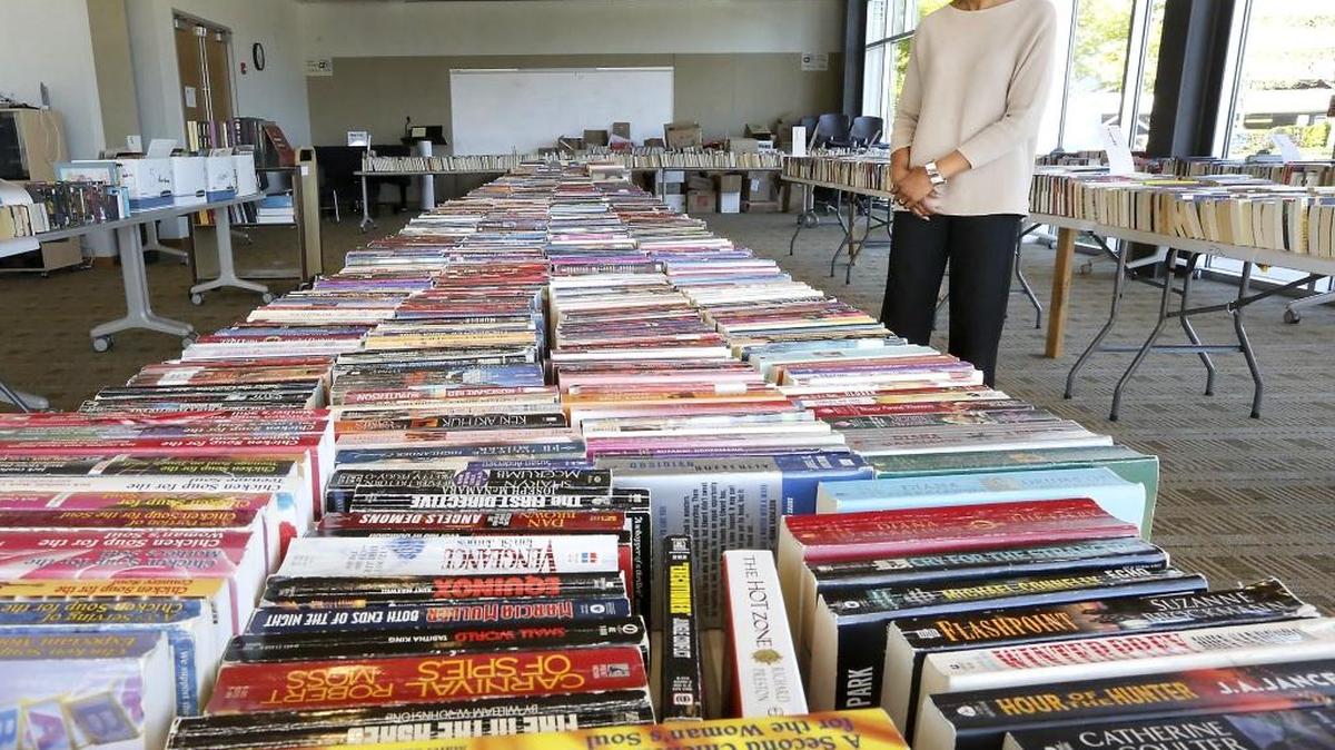 Leslie Campbell Hime, Richland Public Library interim manager, walks past tables covered with thousands of books, magazines, CDs, records and games available for purchase at The Friends of the Richland Public Library spring book sale. The two-day event, beginning Friday, will be held in the Doris Roberts Gallery. Proceeds help fund library programs, public computers, new technology, STEAM programming and the summer reading program. The Friends of the Mid-Columbia Libraries is also holding its spring event on the same days at the Kennewick branch, 1620 S. Union St. Watch a video at tricityherald.com/video