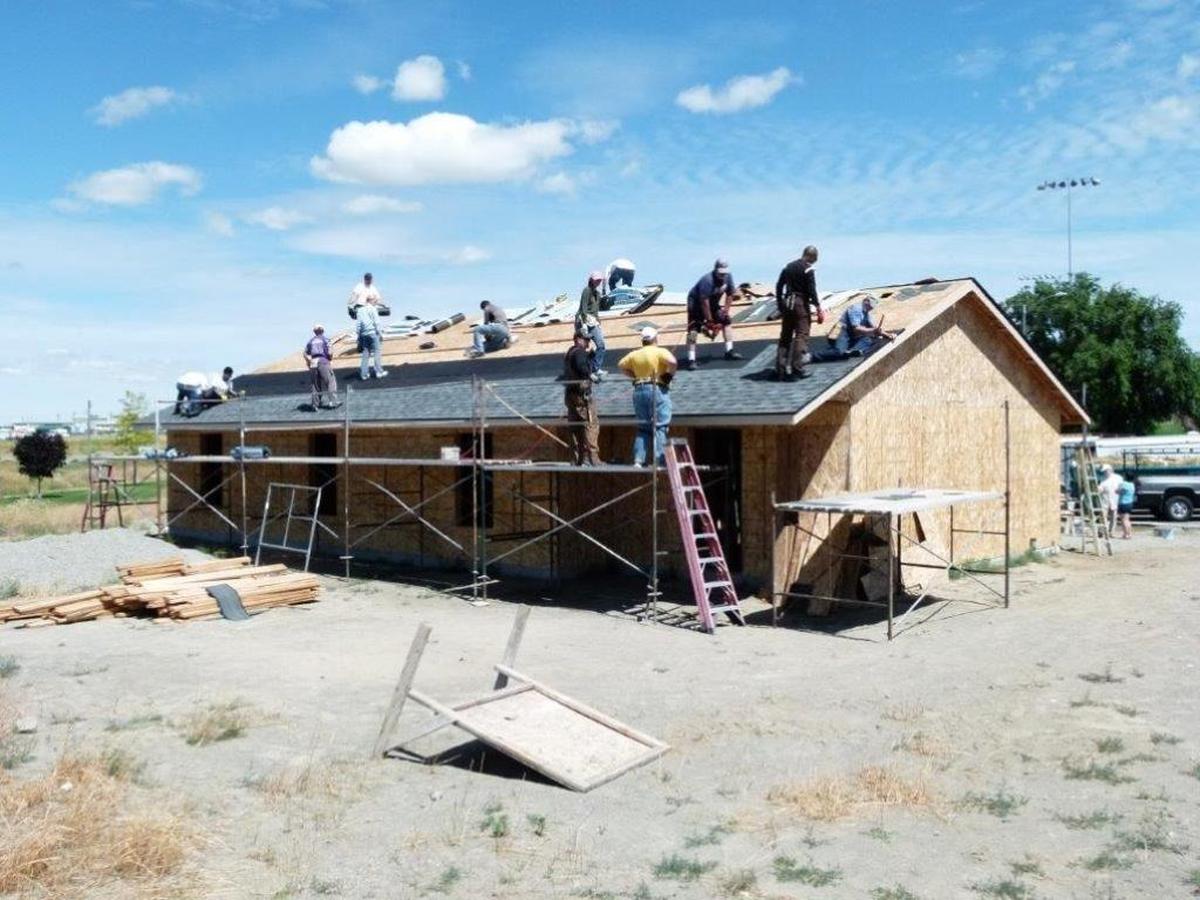 Volunteers with Habitat for Humanity work on a Pasco home earlier this year.