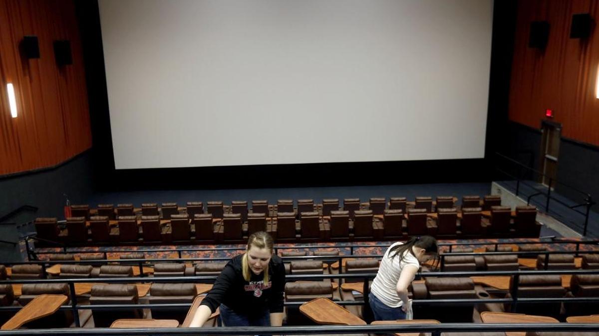 Employees Shaynn Otte, left, of Pasco, and Anjuli Herr of West Richland clean reclining seats Thursday at the new Fairchild Queensgate 12 movie theater on Duportail Street in Richland. Ticket sales start at 11 a.m. Friday and the theater is expected to open next week for the new Star Wars movie.