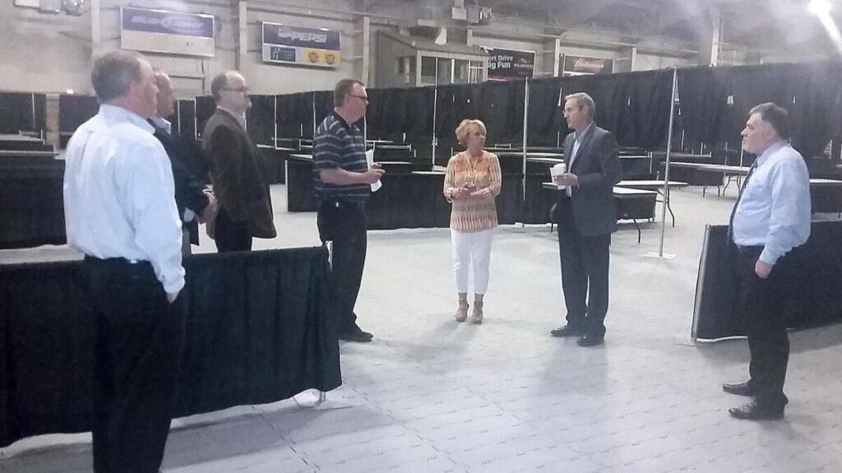Franklin County Commissioner Brad Peck, center, asks TRAC manager Tom French, center left, a question Wednesday during a tour of the Pasco arena. The county is considering replacing the temporary flooring with a paved floor. Also shown, from left, are former commission candidate Rocky Mullen, county Administrator Keith Johnson, county Auditor Matt Beaton, employee Karin Milham and Franklin County Commissioner Rick Miller.
