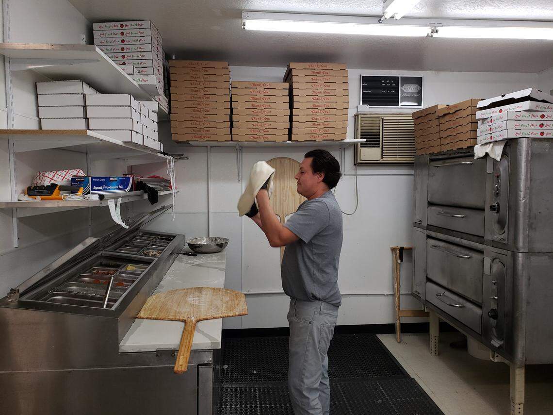 Merced Flores tosses pizza crust at Mercy’s Pizza Taco in Pasco.