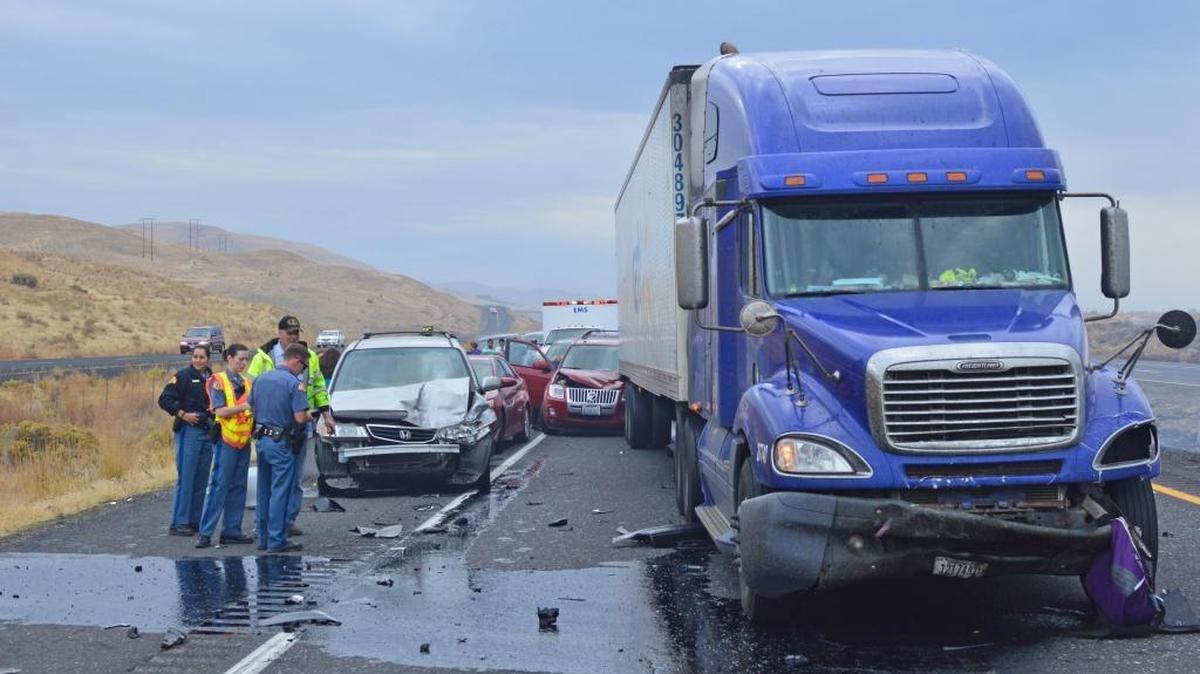 
Police and emergency responders talk Saturday next to a semi-truck and car wrecked in one of two multiple-vehicle crashes on Interstate 82.
