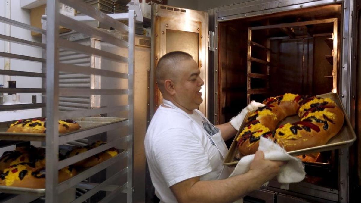 Francisco Mejia, owner of Francsco's Bakery, takes a tray of Rosca de Reyes out of the oven Wednesday at the bakery in Kennewick. The traditional Mexican "bread of kings" is eaten by families on January 6th to celebrate the arrival of three wise men at the site of Jesus' birth. Mejia, who has been a baker for 25 years, estimates his shop made 150 loafs for the holiday this year. "The most important thing about this tradition is that it brings families together," he said. Customarily whomever finds the baby Jesus toy has to cook dinner for the entire family on February 2nd.