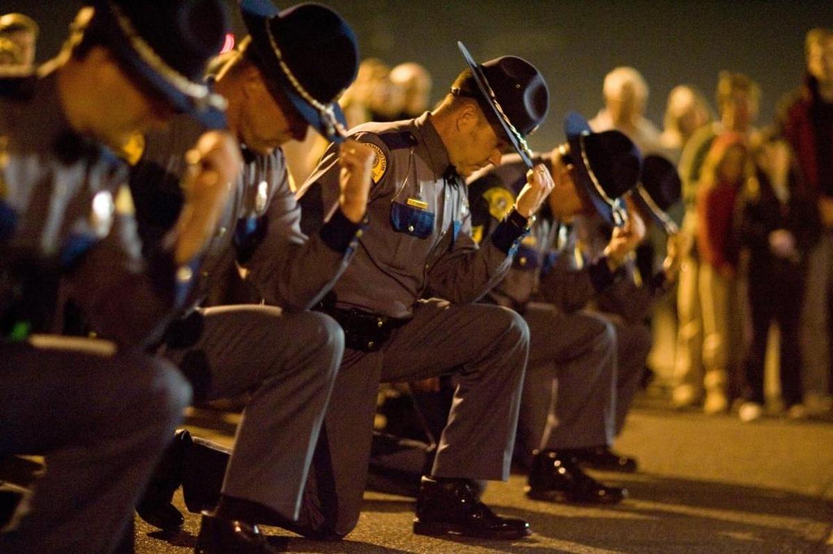 Washington State Patrol Trooper James E. Saunders’ academy classmates perform a 21-bell salute during a memorial service on the 10th anniversary of his death. The salute is an alternative to a 21-gun salute. Saunders was shot multiple times on Oct. 7, 1999, after stopping a truck at Road 28 and Lewis Street in Pasco.