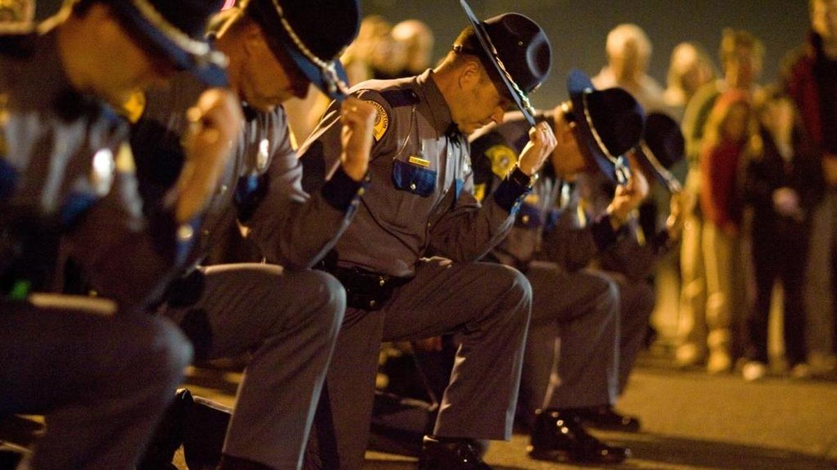 Washington State Patrol Trooper James E. Saunders’ academy classmates perform a 21-bell salute during a memorial service on the 10th anniversary of his death. The salute is an alternative to a 21-gun salute. Saunders was shot multiple times on Oct. 7, 1999, after stopping a truck at Road 28 and Lewis Street in Pasco.