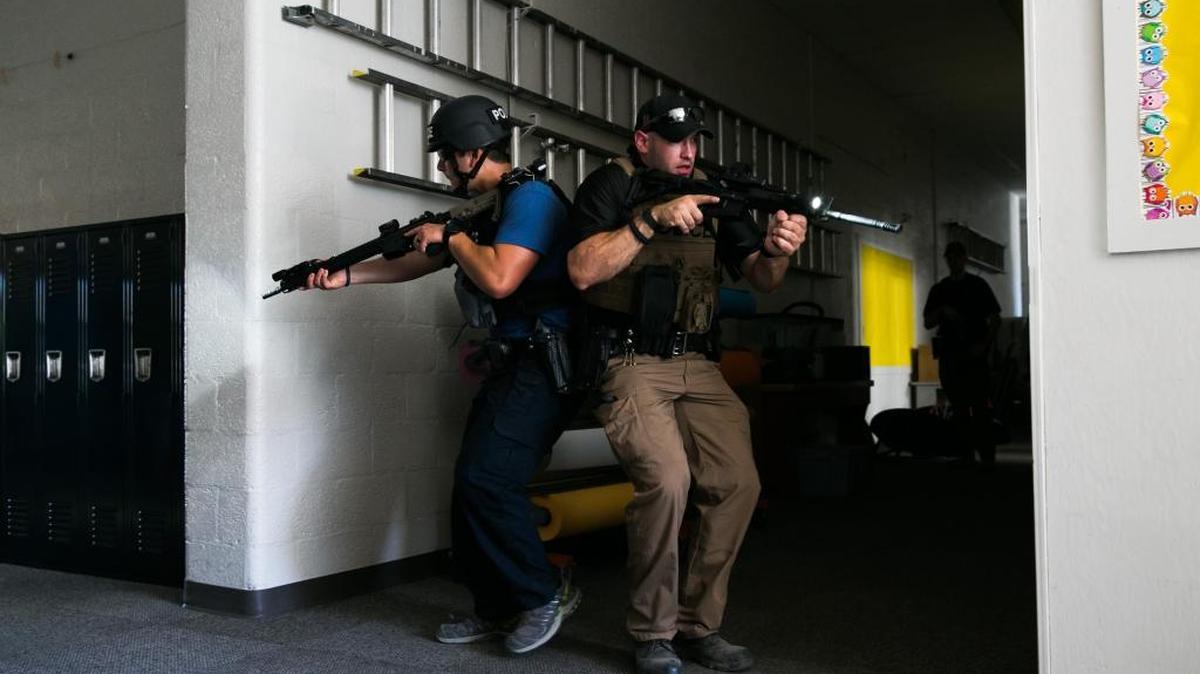 Yakima Police Officers Philip Amici, left, and Ryan Davis participate in a blind corner drill during an active shooting training at St. Joseph-Marquette School in Yakima.