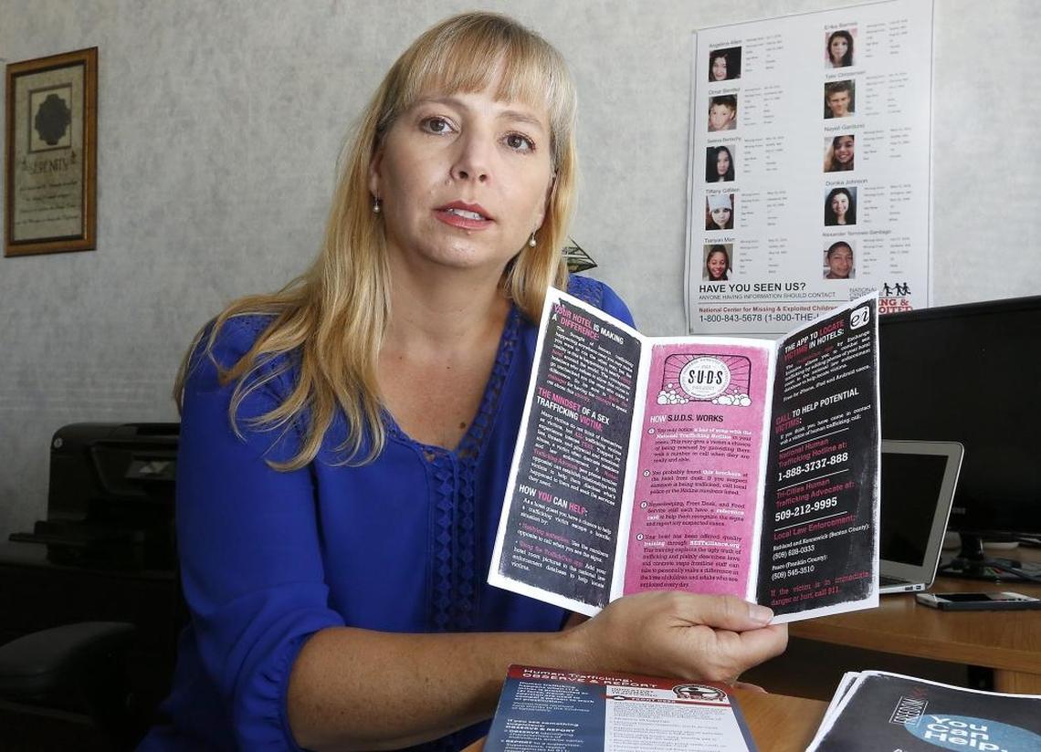 Tricia MacFarlan, executive director of Mirror Ministries, shows an informational pamphlet placed in area hotels to help educate customers and employees on how to spot potential human and sex trafficking incidents.