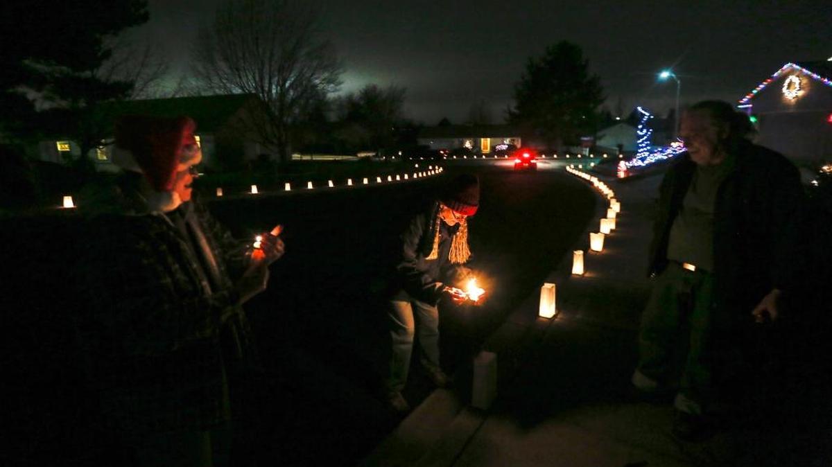 Neighbors light up their luminarias for the 32nd annual Desert Plateau Luminaria in Pasco on Saturday. More than 25,000 candle-filled paper sacks, or luminaries, lined the streets of Desert Plateau and surrounding neighborhoods.