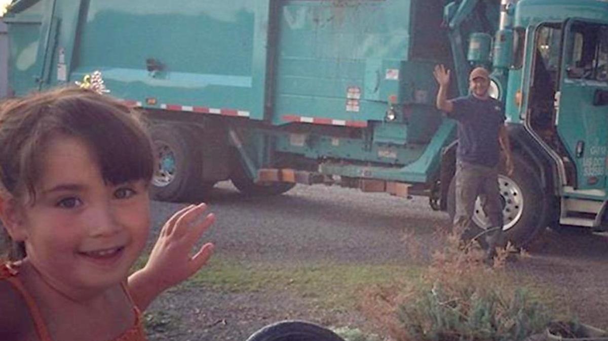 
Gigi Campbell, 4, smiles as Fred Gomez with Ed’s Disposal brings his garbage collection truck by her West Richland home. She met the truck outside most Tuesdays for six months.
