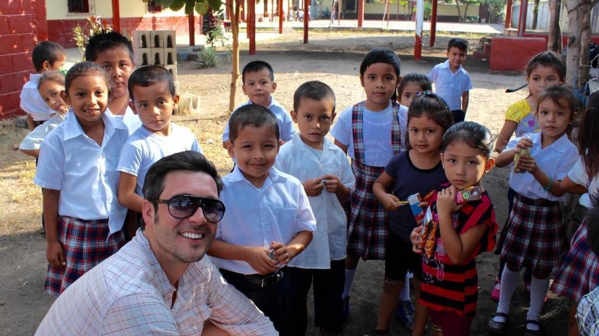 Dr. Bart Roach, owner of Three Rivers Dental in Kennewick, poses with primary students at La Gomera school, Escuintla, Guatemala.