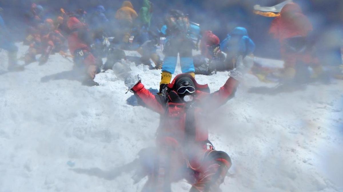 Ice on the camera lens frames Paula Leonard, a nurse at Kennewick’s Trios Health, as she celebrates reaching the top of Mount Everest on May 19.