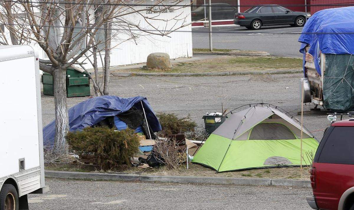 Tents were pitched in a parking lot island in 2018 near a food kitchen in Kennewick.