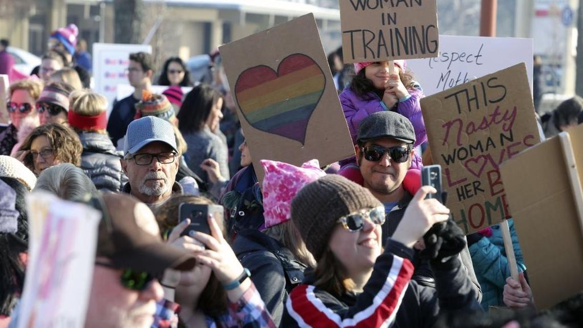 Dahlia Del Toro, 4, of Kennewick, holds a sign reading “Nasty Woman in Training” as she sits on her father, Jorge, with her mom Sarah on Saturday as they attend the Tri-Cities Women’s March at John Dam Plaza in Richland. See a photo gallery at tricityherald.com