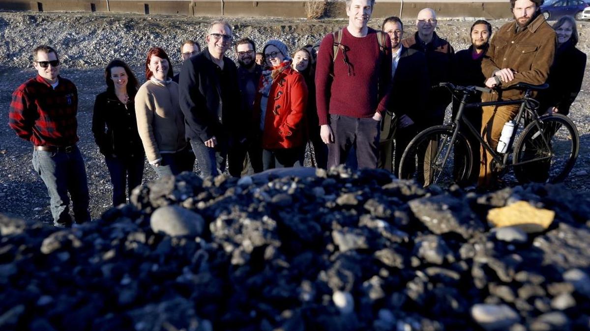 File: Adam Brault, center, is joined by other supporters of the “Grand Bargain,” a package of public facilities districts, for a group photo in this file photo at the pit along George Washington Way in Richland.