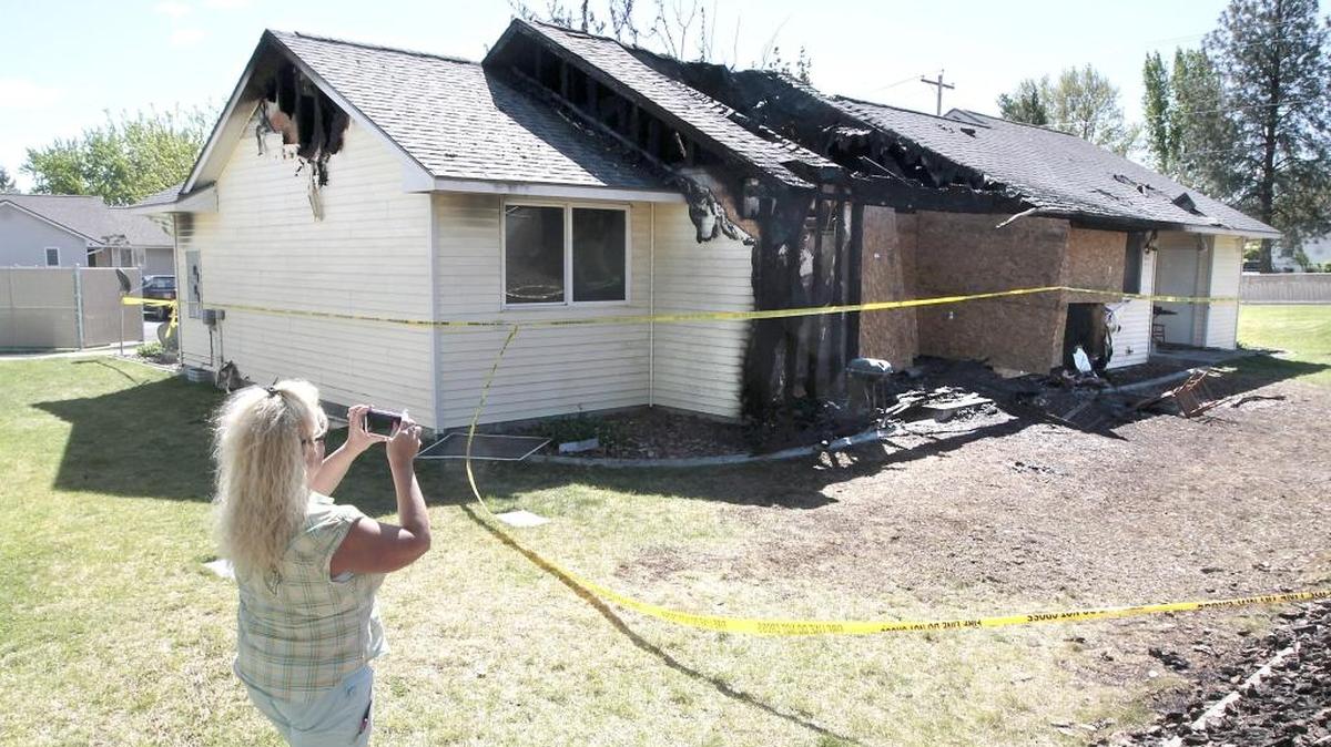 Kirsten Beaman, rural development employee with the U.S. Department of Agriculture, documents the fire damaged duplex at 1280 Hazel Ave. on Friday morning in Benton City. The duplex caught fire Thursday night and displaced two families from the federally subsidized Cherryhill Villas farmworker housing project. Officials estimate the damage at $250,000. No one was injured. One family was relocated to a vacant unit in the 48-unit complex. The cause is still under investigation.