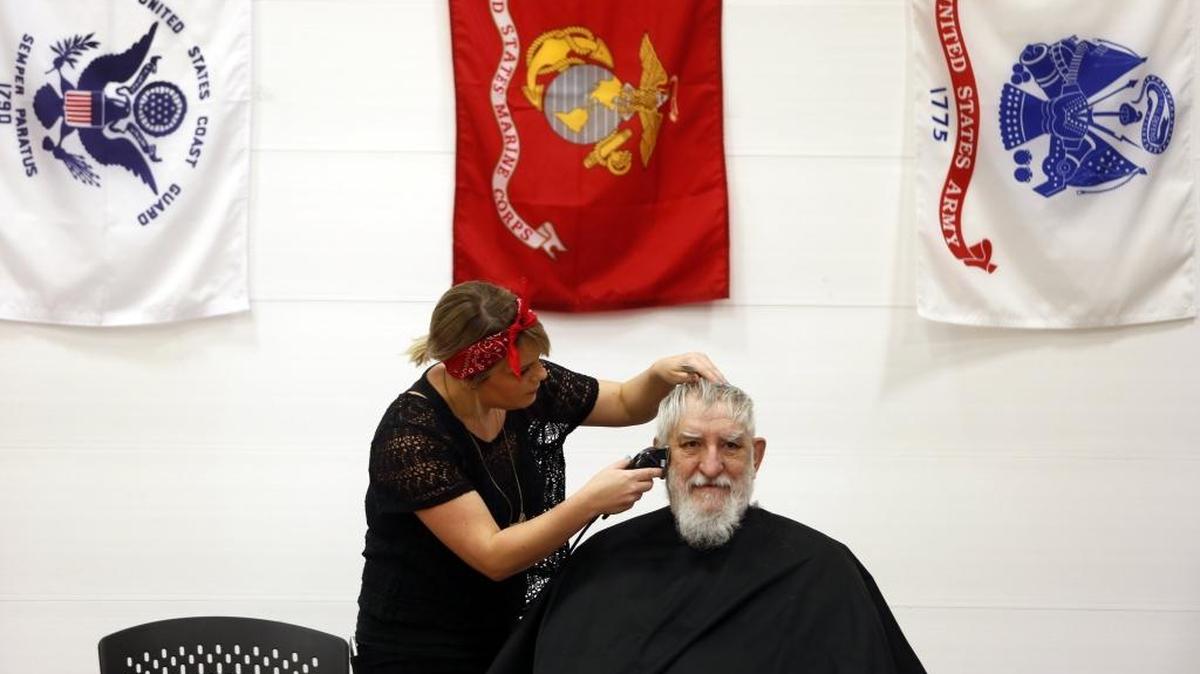 Veteran David Mosley, of Pasco, who served in the Army, National Guard and Air Force from 1967-1992, gets a haircut from Paul Mitchell Beauty School student Danielle Curtis, of Richland, Friday during the Columbia Basin Veterans Stand Down event at the Southridge Sports Pavilion. The event, organized by the Columbia Basin Veteran's Coalition, provided local veterans with goods and services from flu shots to meetings with area employment services. See a video at www.tricityherald.com.