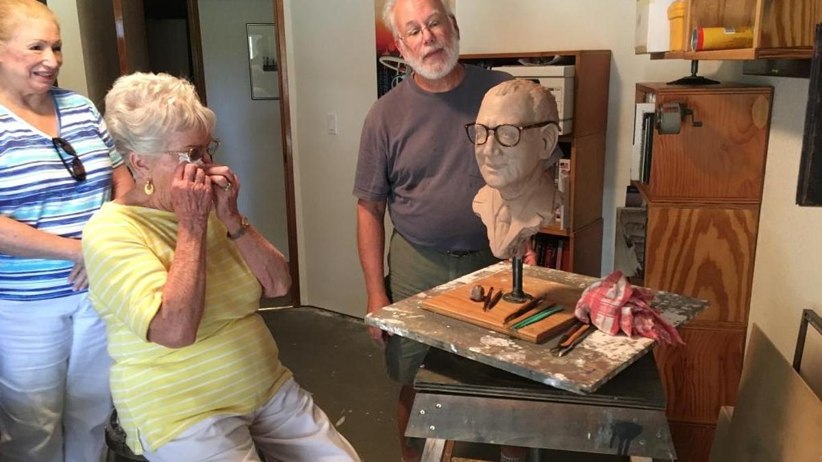 Pat Johnstone Jones, widow of philanthropist George Jones, reacts as she sees a mold for a bust made by sculptor Tom McClelland, right, in tribute to her late husband. The bronze bust will be unveiled Feb. 16 on what would have been Jones’ 100th birthday.