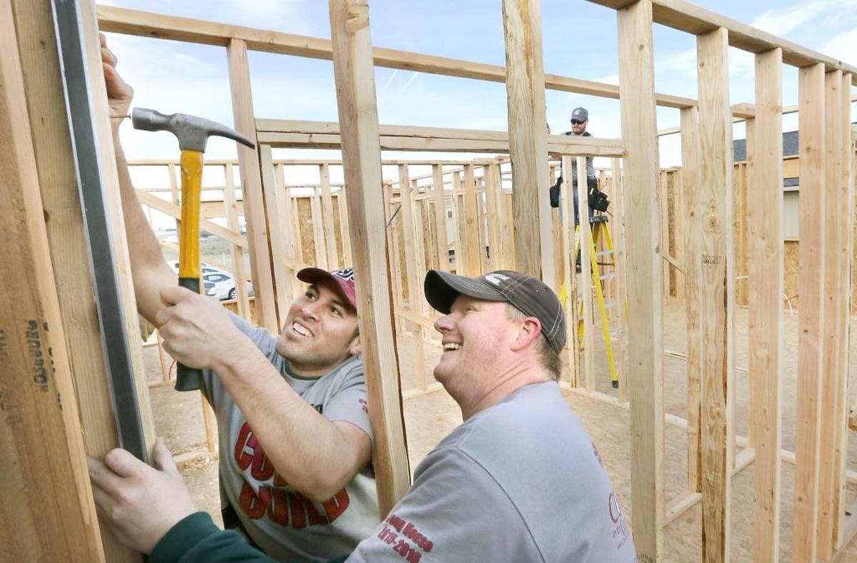 Luis Zecena, left, Brent Ellis and Eric Loefller, far right, work on a Habitat for Humanity house sponsored and built by Washington State University Tri-Cities students in Richland in 2016.