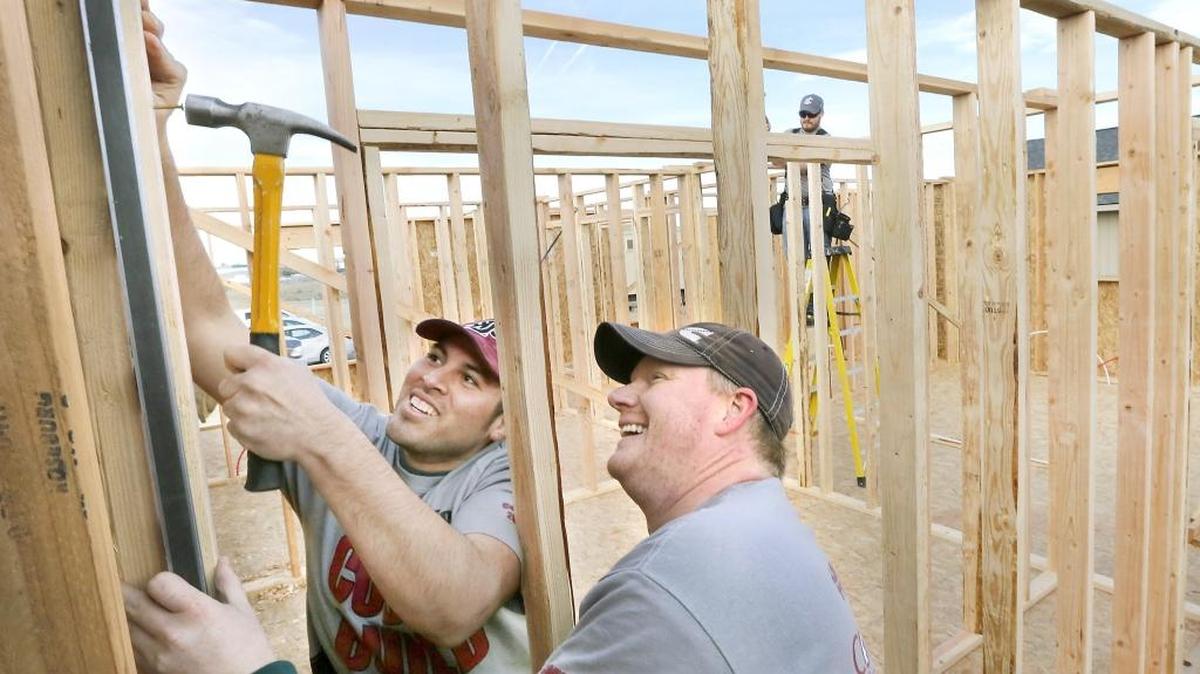 Luis Zecena (left), Brent Ellis and Eric Loefller (far right) work Monday at a Habitat for Humanity house sponsored and built by the students of Washington State University Tri-Cities in Richland. The three students spent part of their Presidents Day holiday volunteering at the 1,000-square-foot home under construction at 304 N. Charles St. in Pasco. Watch a video at www.tricityherald.com/video