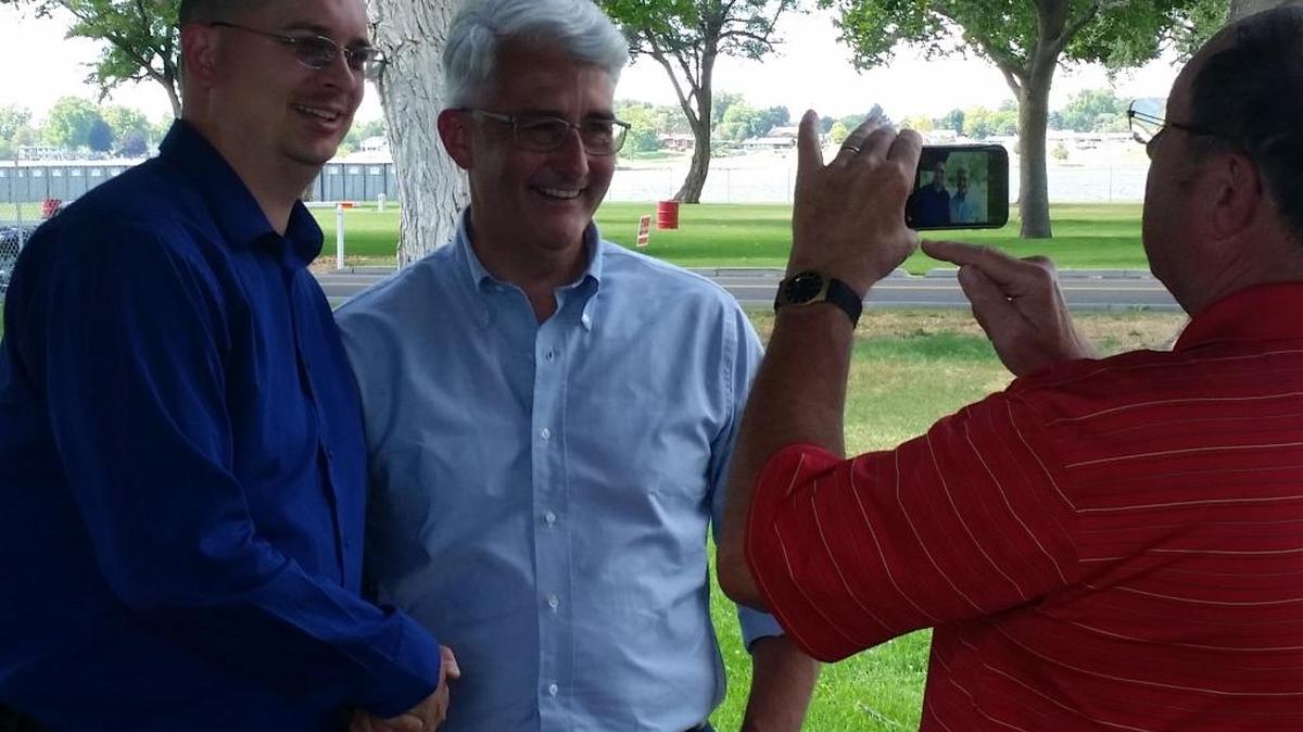 Bill Bryant, Republican candidate for Washington governor, center, poses for a photo with Ryan Cooper, Libertarian candidate for the state House, during an appearance Friday at a Republican rally at Kennewick’s Columbia Park.