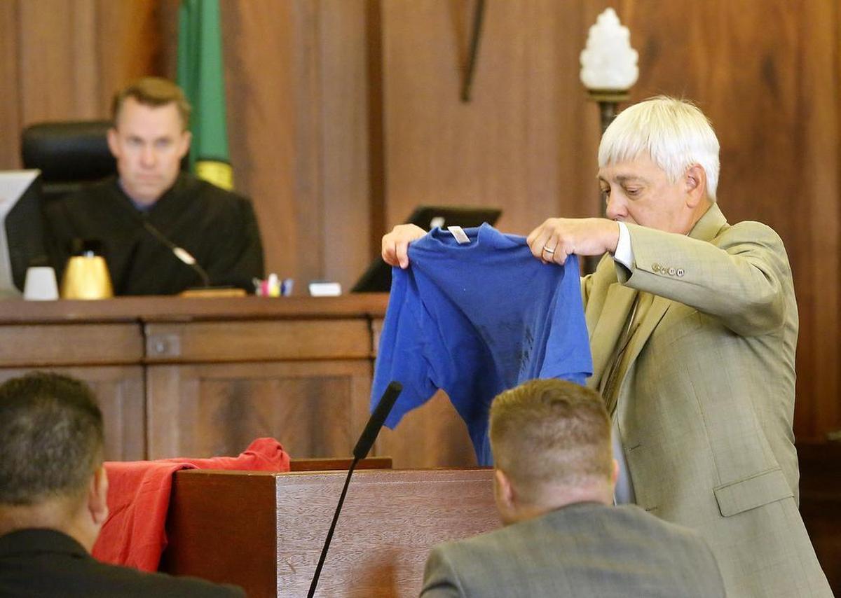 Franklin County Deputy Prosecutor Dave Corkrum places a red and blue T-shirt on the lectern in August 2017 during his opening statement in a murder trial in Pasco.