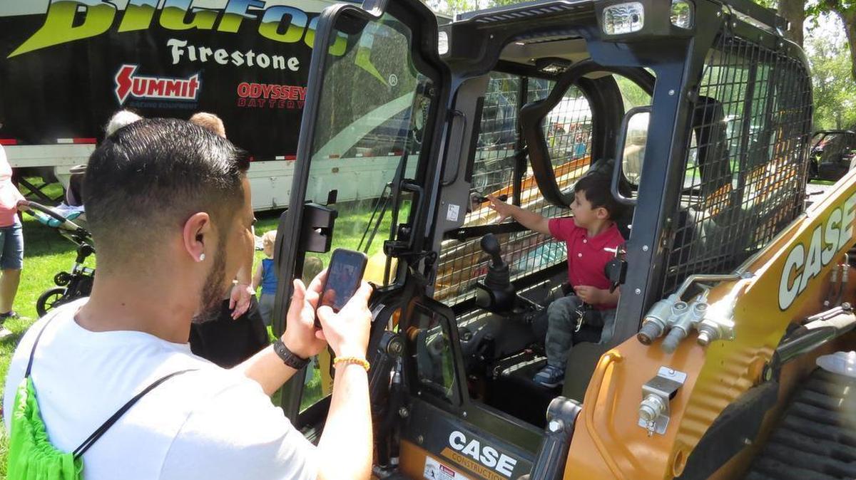 Jason Mendoza, of Kennewick, takes a picture of his son, Treyton, 3, inside a Bobcat during Kidz Dig Rigz at Columbia Park last year. Volunteers are being sought for this year’s event.
