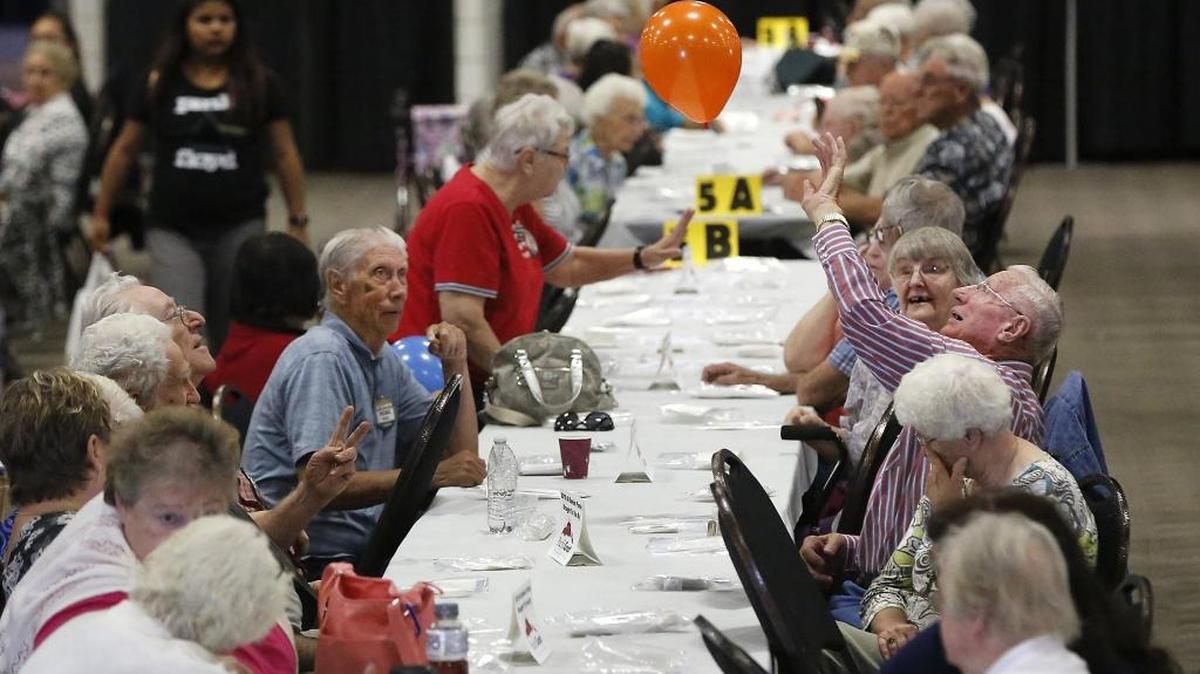 Bob Metzinger of Kennewick playfully hits a balloon across the table Thursday morning while attending the annual All-Senior Picnic held this year at the TRAC center in Pasco. Student volunteers from Tri-Cities Prep and the Tri-Tech Skill Center radio broadcasting program served lunches and drinks to about 800 people attending the event. Pasco, Kennewick and Richland take turns holding the event that features food, a live band, entertainment and community vendors. Watch a video at tricityherald.com/video