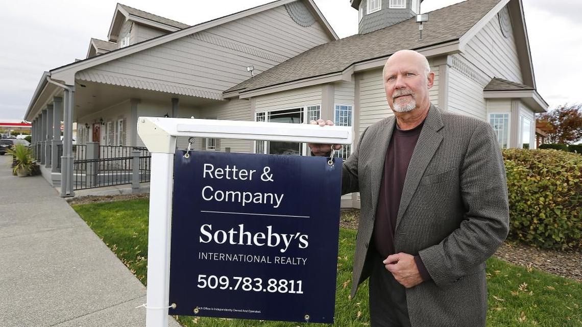 Dave Retter, owner of the largest real estate firm in the Tri-Cities, holds one of the new yard signs debuting the new name and brand for his residential real estate company affiliation — Retter & Company Sotheby’s International Realty.