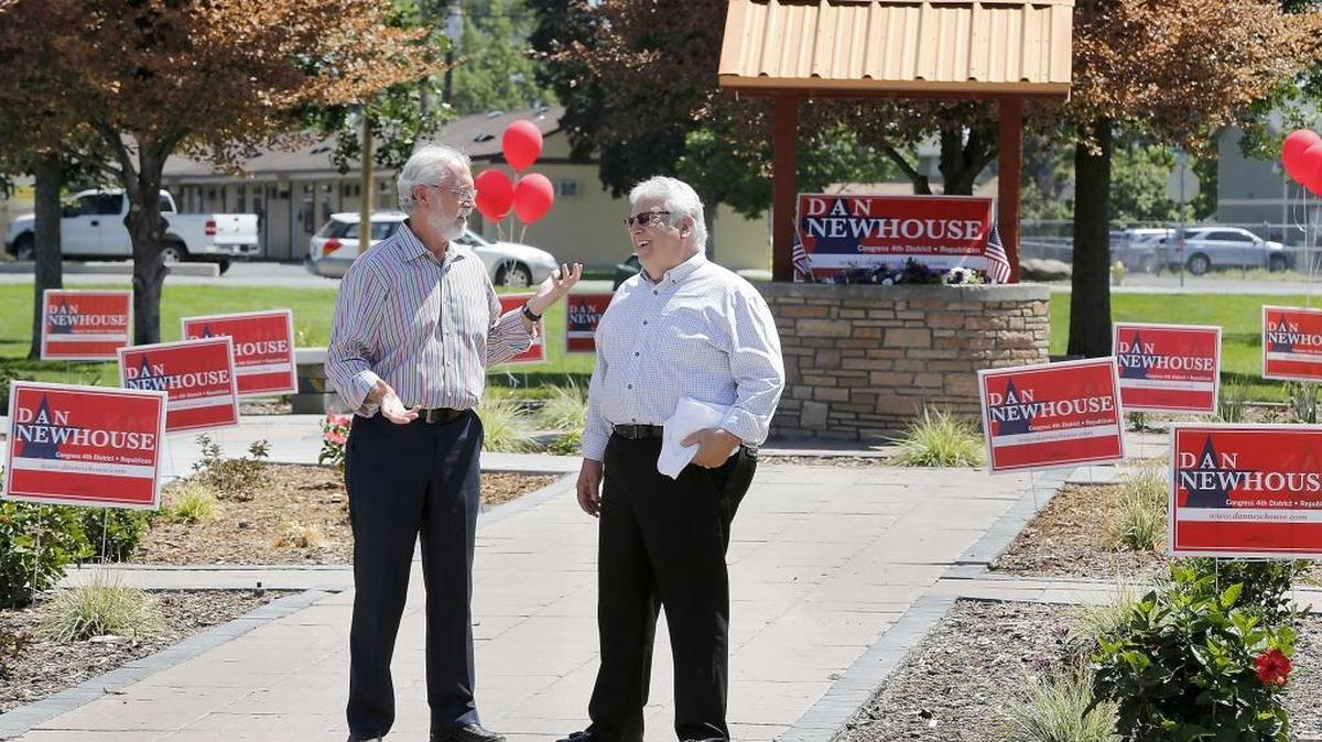 U.S. Rep. Dan Newhouse, R-Sunnyside, left, and Skip Novakovich, a retired Army lieutenant colonel, share a moment Monday during a re-election rally for Newhouse at Volunteer Park in Pasco. Newhouse used the event and another later in Richland to remind voters to turn in their ballots for next week’s state primary election day. Watch a video at tricityherald.com/video.