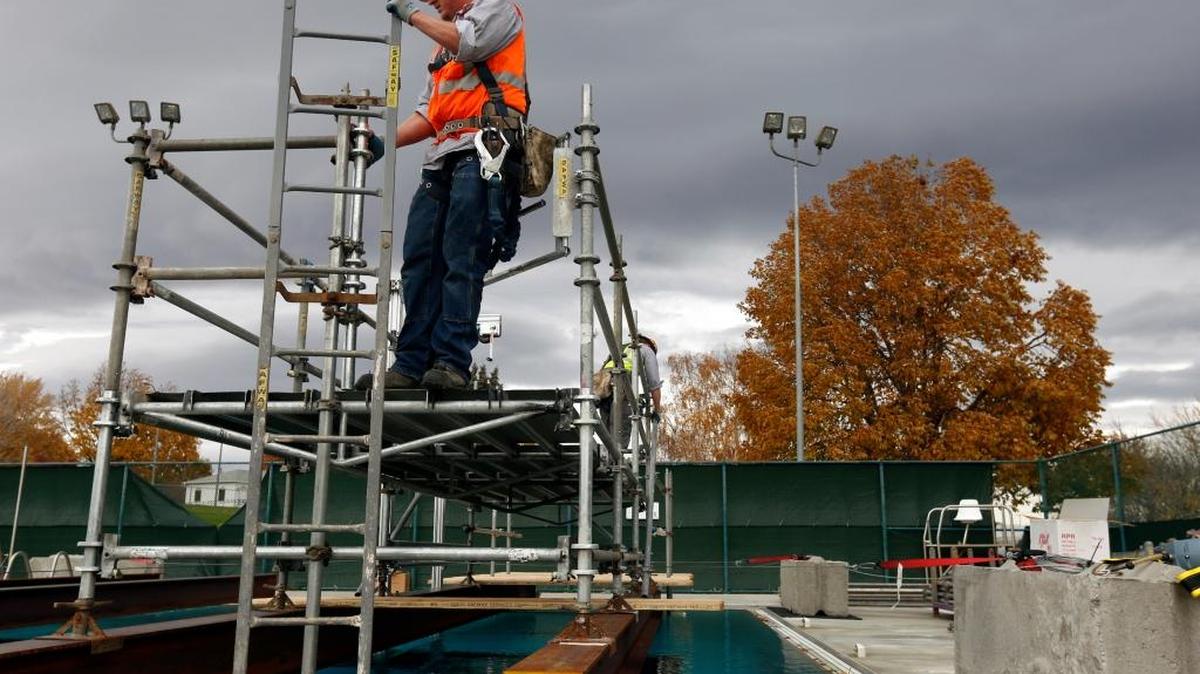 Ryan Ricard, left, and Jordan Rada, with Safway Services in Pasco, work to set up scaffolding Friday at the George Prout Memorial Pool in Richland for a test by Pacific Northwest National Laboratory. The PNNL team is testing the systems used to protect radioactive materials at sterilization facilitates around the nation. No radioactive materials were used at the pool. See video at tricityherald.com/video.