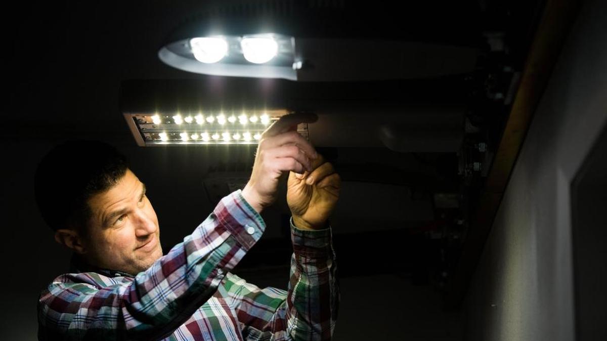 Michael Poplawski, a Pacific Northwest National Laboratory engineer, works with outdoor streetlights at a converted warehouse in Portland. The new lighting test bed allows researchers to assess the capabilities of sophisticated new lighting systems.
