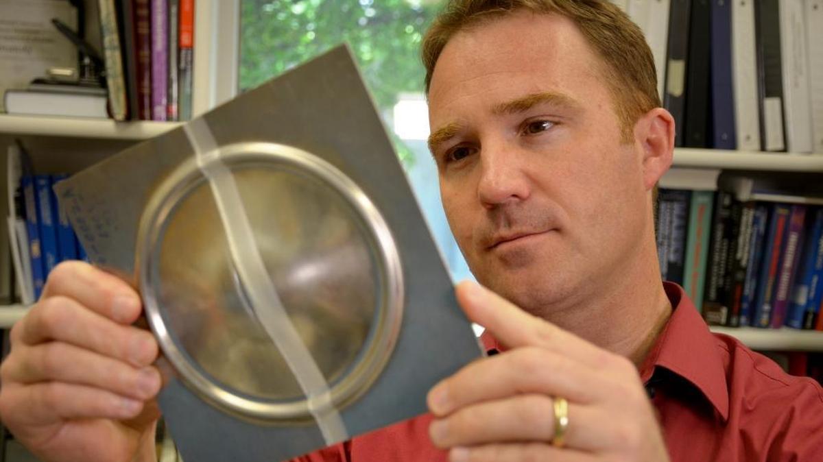 PNNL researcher Yuri Hovanski inspects the quality of the new type of weld that could help increase the use of light-weight aluminum in vehicles. PNNL has worked with General Motors on the technology.