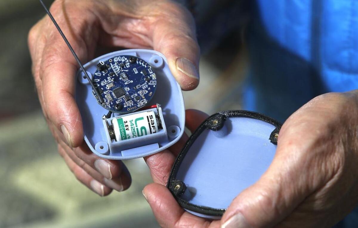 Jim Skorpik, chief engineer at PNNL, shows the internal components of the portable battery-operated acoustic gunshot detector he created at the Richland facility. Watch a video at tricityherald.com/video