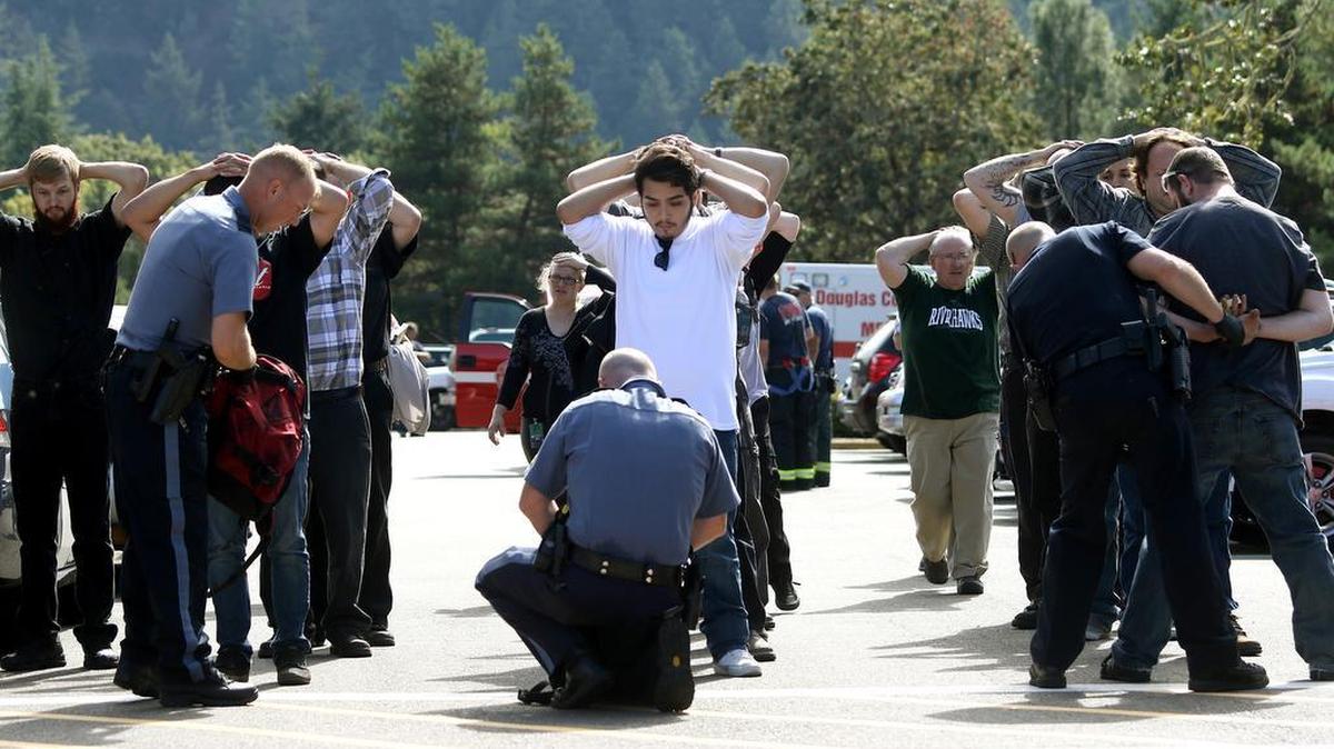 
This photo from Oct. 1 shows police searching students outside Umpqua Community College in Roseburg, Ore., following a deadly shooting at the college.
