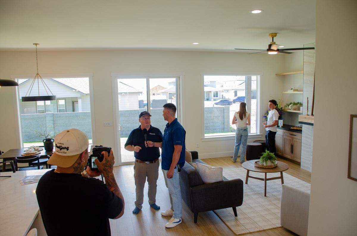 Families, media and stakeholders tour Team Pasco’s 26th home built during a Thursday dedication event. The 2,016-square-foot, single-floor home features three bedrooms, a covered patio, and a study-flex area all in an open concept. Century 21 Real Estate listed it for sale at $534,900.