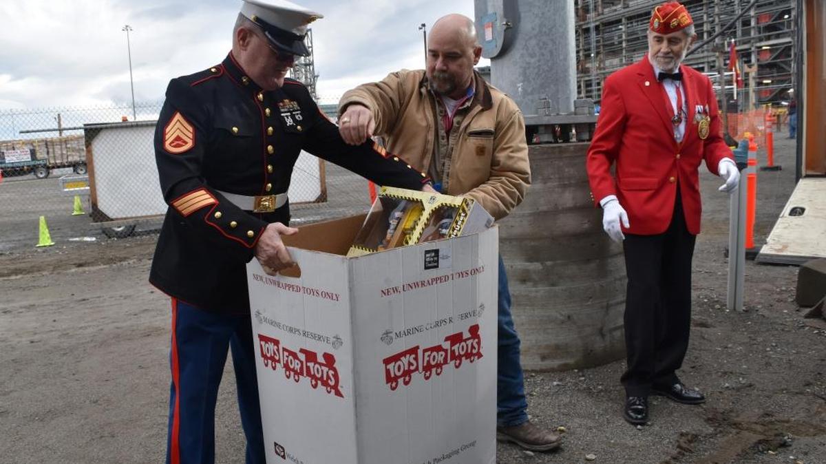 Toys from the Vit Plant's 2015 U.S. Marine Corps Reserve's Toys for Tots campaign are loaded into a trailer to prepare them for delivery to needy families in the community. Pictured, from left, are Glen Carter, Toys for Tots coordinator; Andrew Lacey, Bechtel superintendent; and Anthony Tonda, Marine Corps League representative.