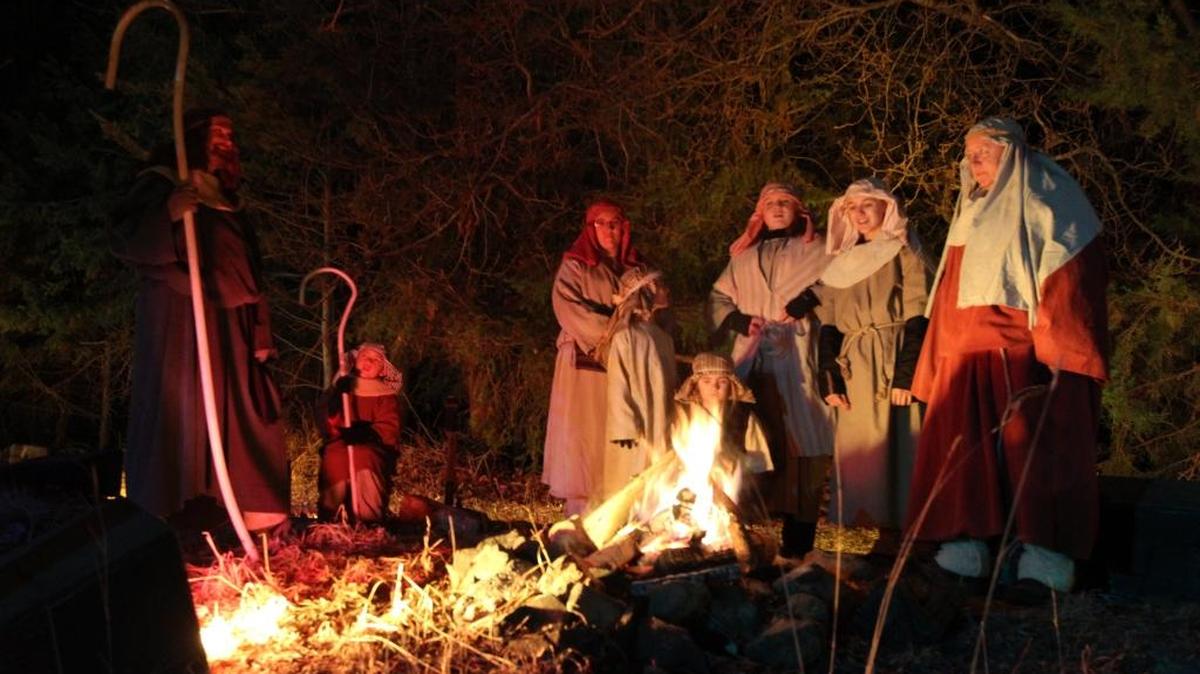 Volunteers dressed as shepherds warm by a fire during a dress rehearsal of the Living Nativity in Richland in this file photo.