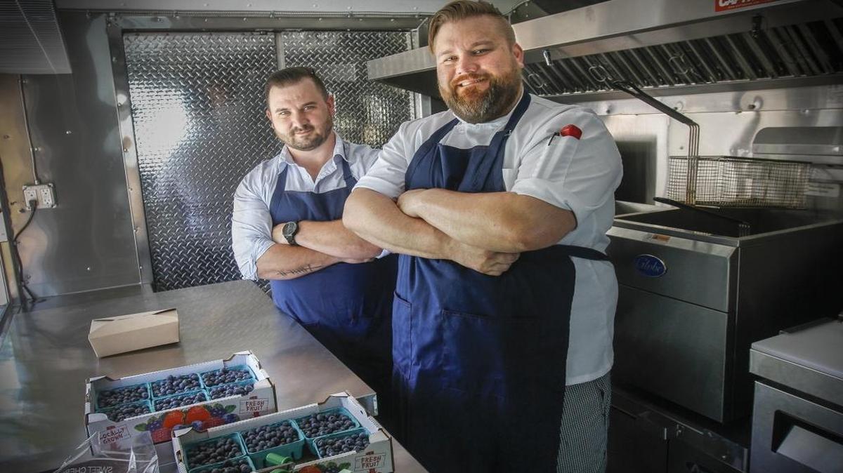 Operator Zac Mason, left, and chef Andrew Grassick stand inside their food truck, Gourmet Grub, which debuts on Friday in Kennewick. Mason and Grassic are also co-owners of Gourmet Grub.
